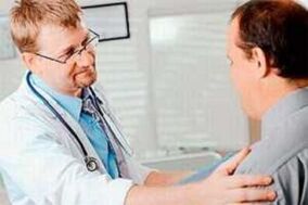 A man with a man with prostatitis at the appointment of a doctor